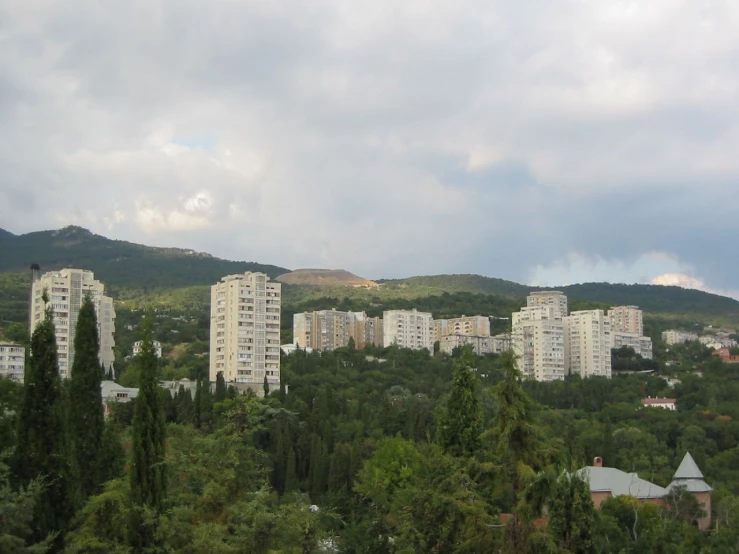 a city with many buildings surrounded by trees
