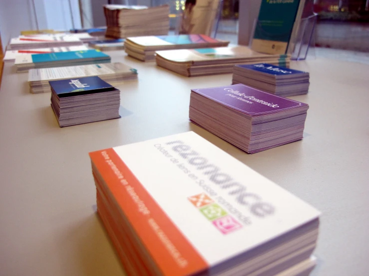 several business cards sitting on a table with phones