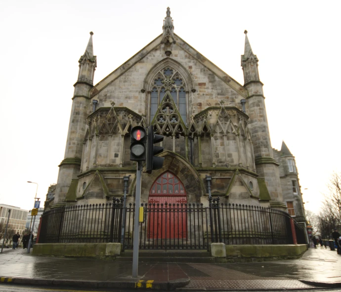 a stone church in the rain with a red door