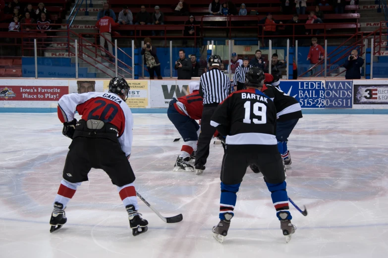 some players are playing a game of ice hockey