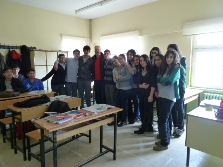 a group of students standing in front of the room