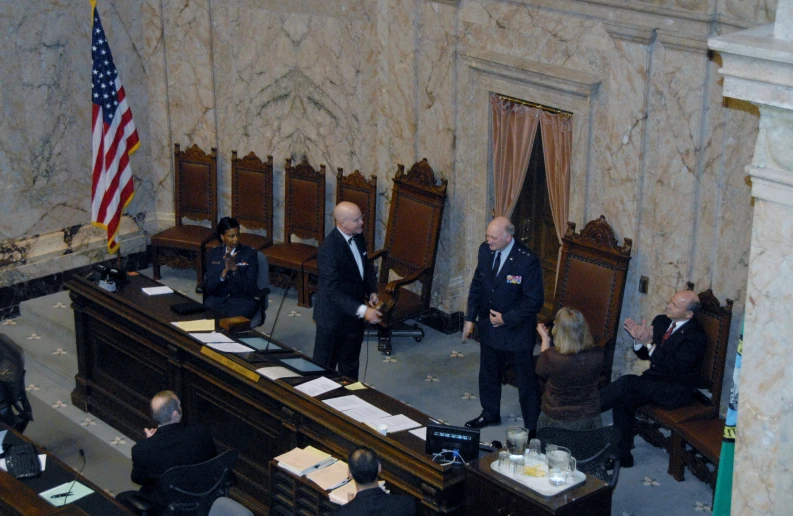 a couple of people sitting in chairs in a room