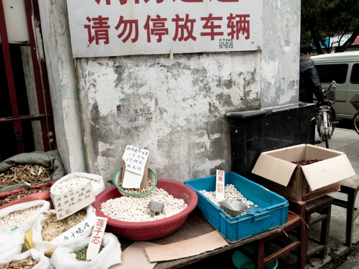 containers of grain on display at street vendor in china