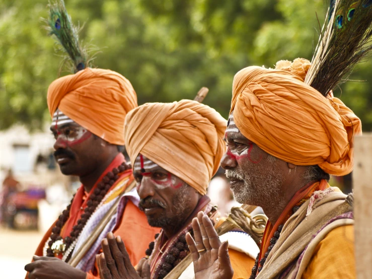 the men are performing with their feathers on their head