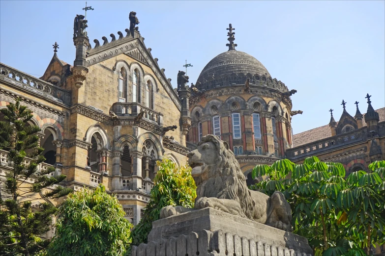 a building with two towers and a statue of a lion