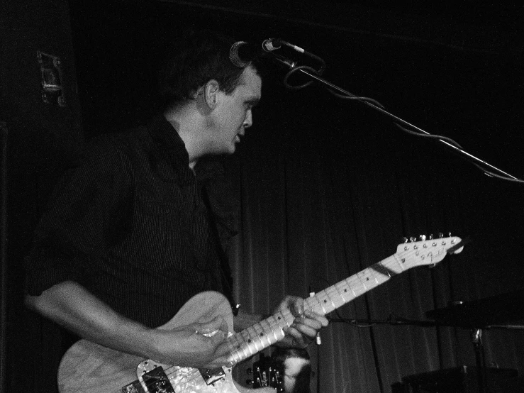 a man playing a guitar on stage