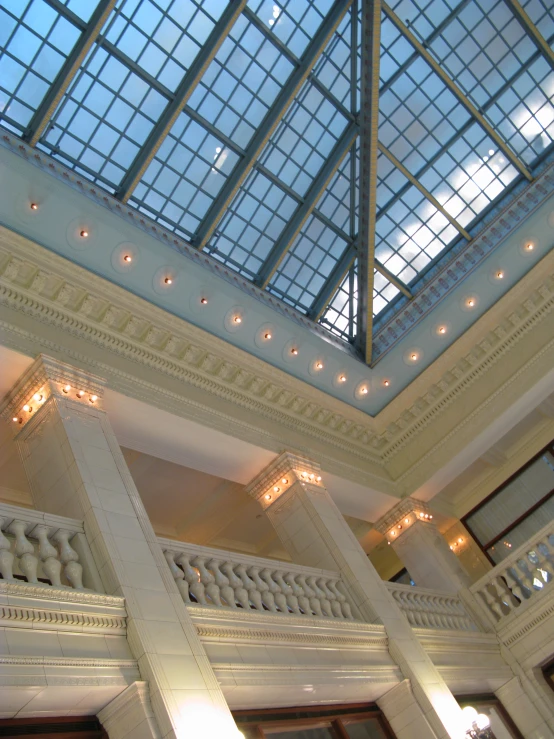 the top of a building with glass ceiling and light fixtures