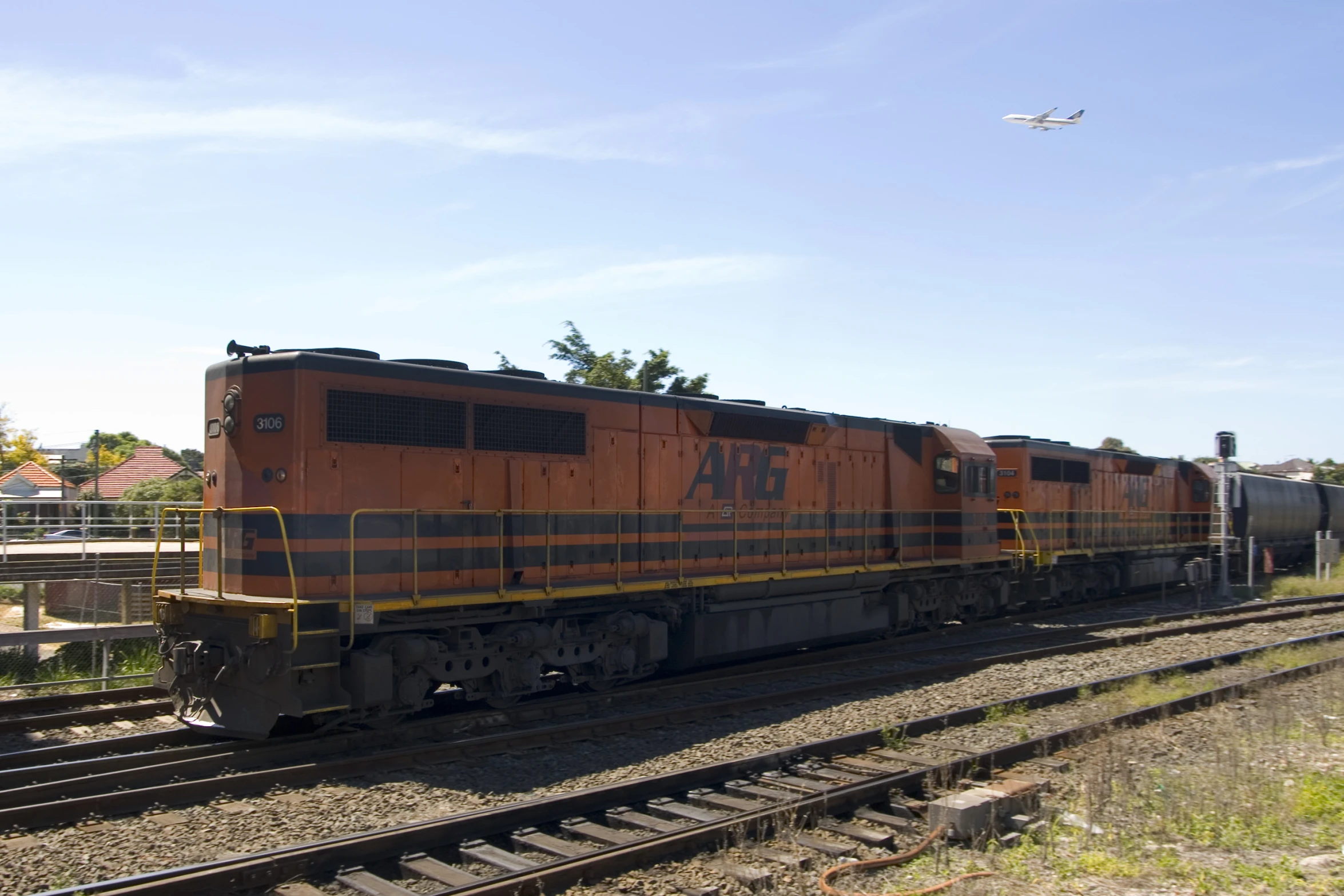 a large orange train sitting on the tracks