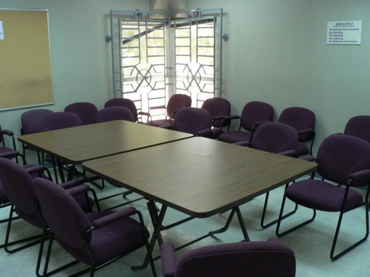 an empty room has chairs and a large board