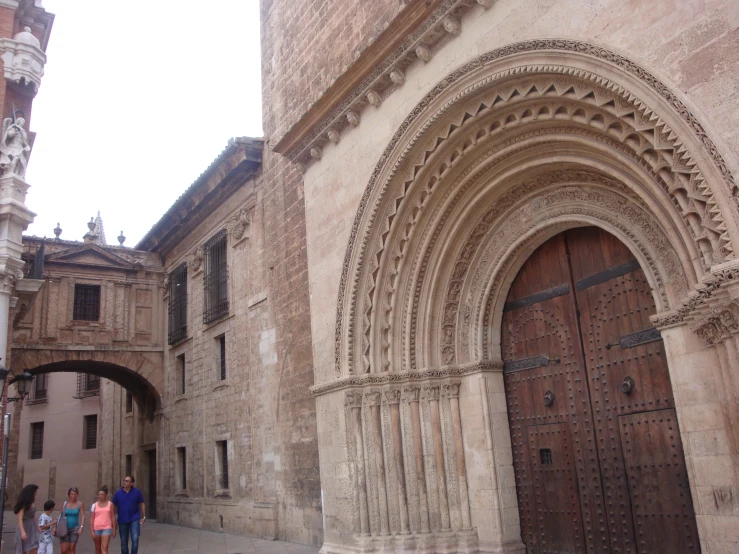 some people walking by the old building entrance