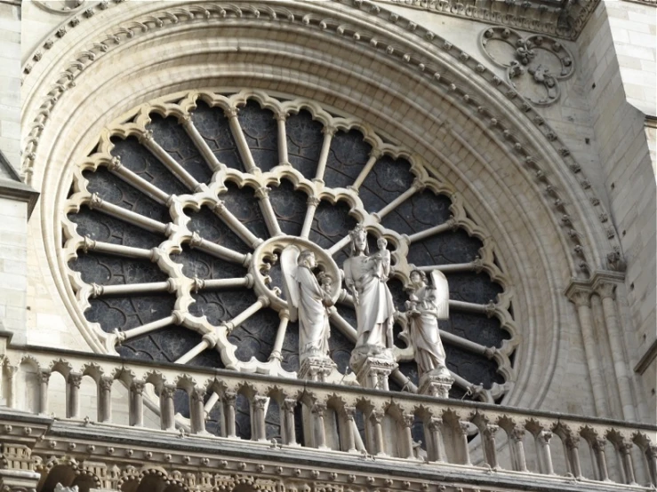 closeup of the rose window on the outside of a gothic building