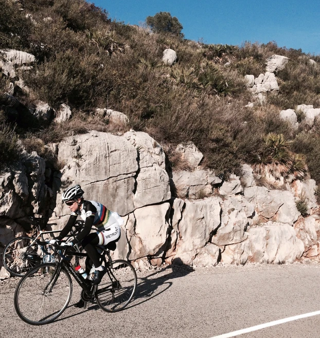 the two men are on their bikes riding down the hill