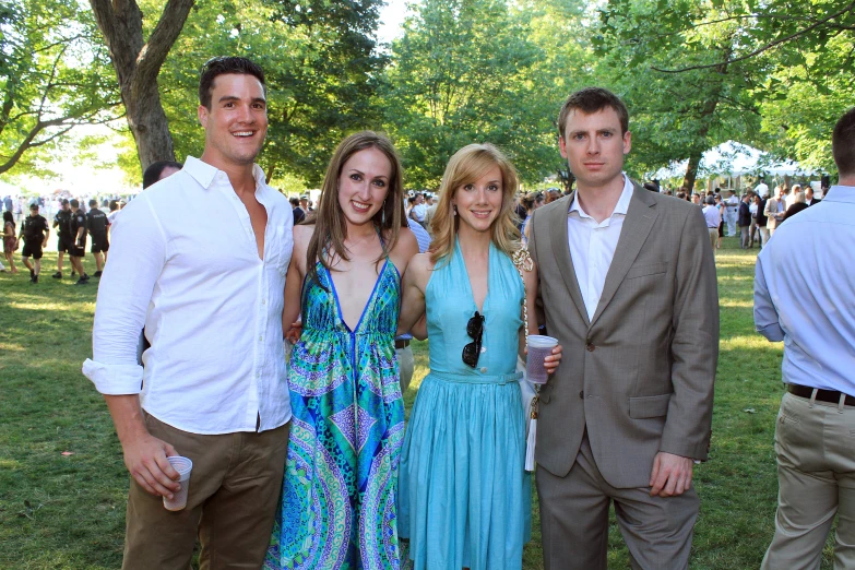 a family gathered at a gathering in a park