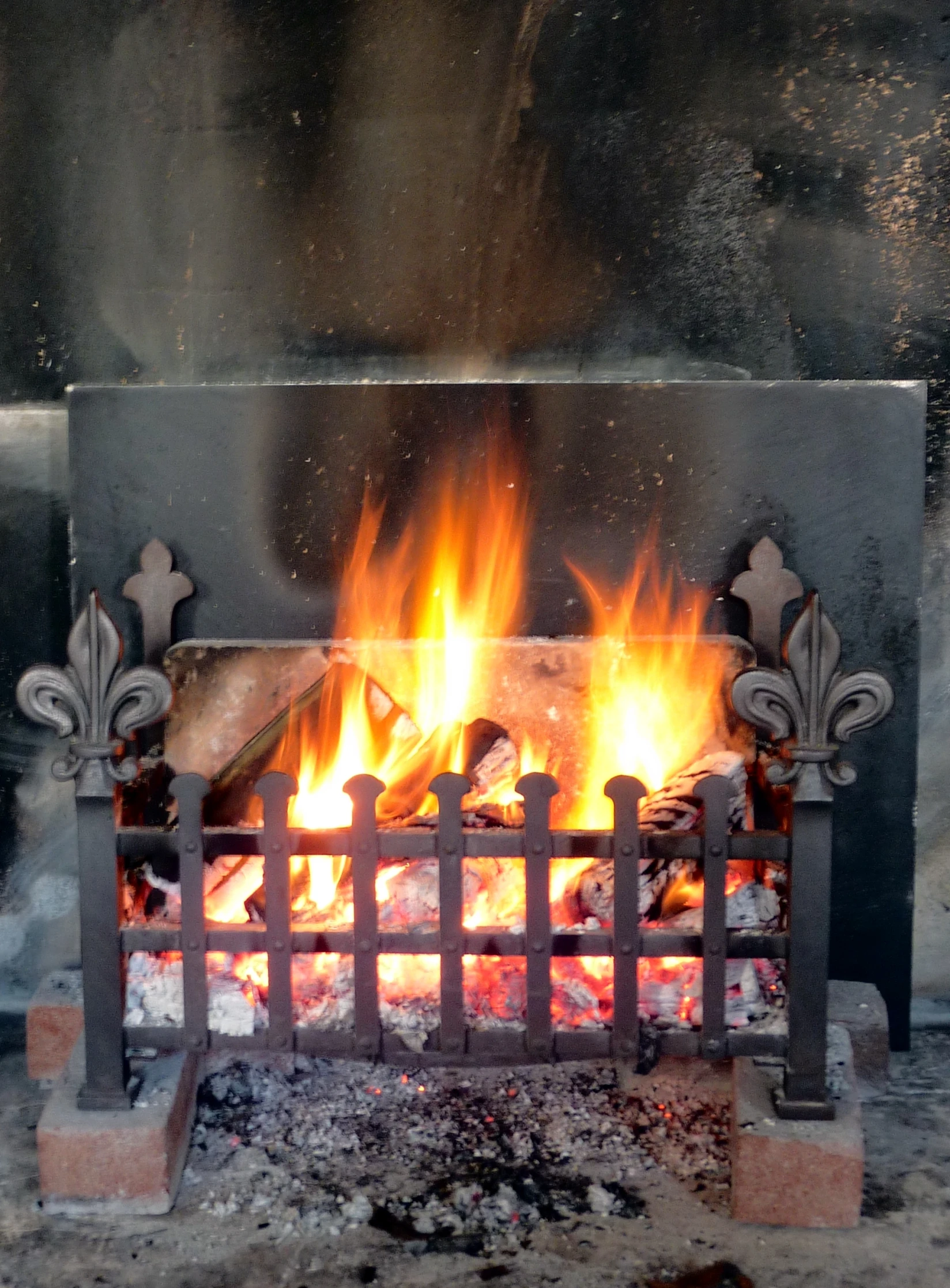 a fire burning inside of an open fireplace