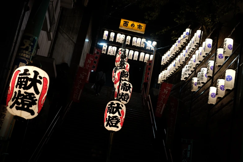 a lighted sign in an alley way at night