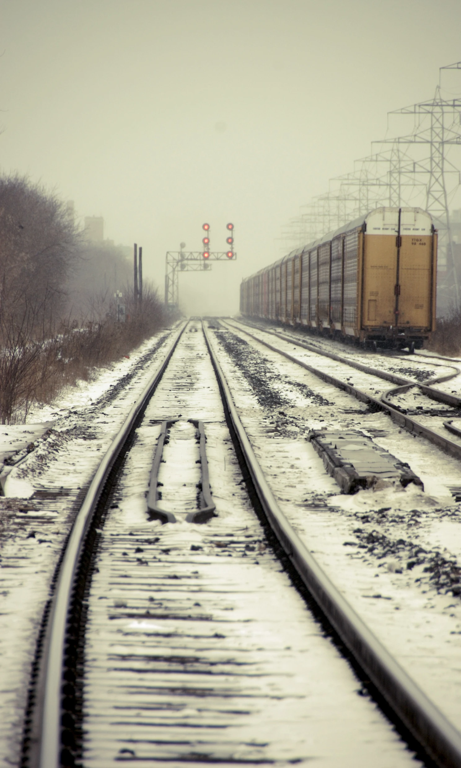 a train track running through a snowy landscape