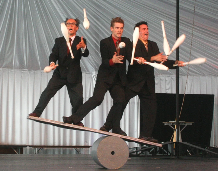 several people are performing a show on a long skateboard