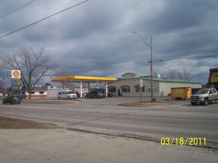 cars parked in the parking lot at a gas station