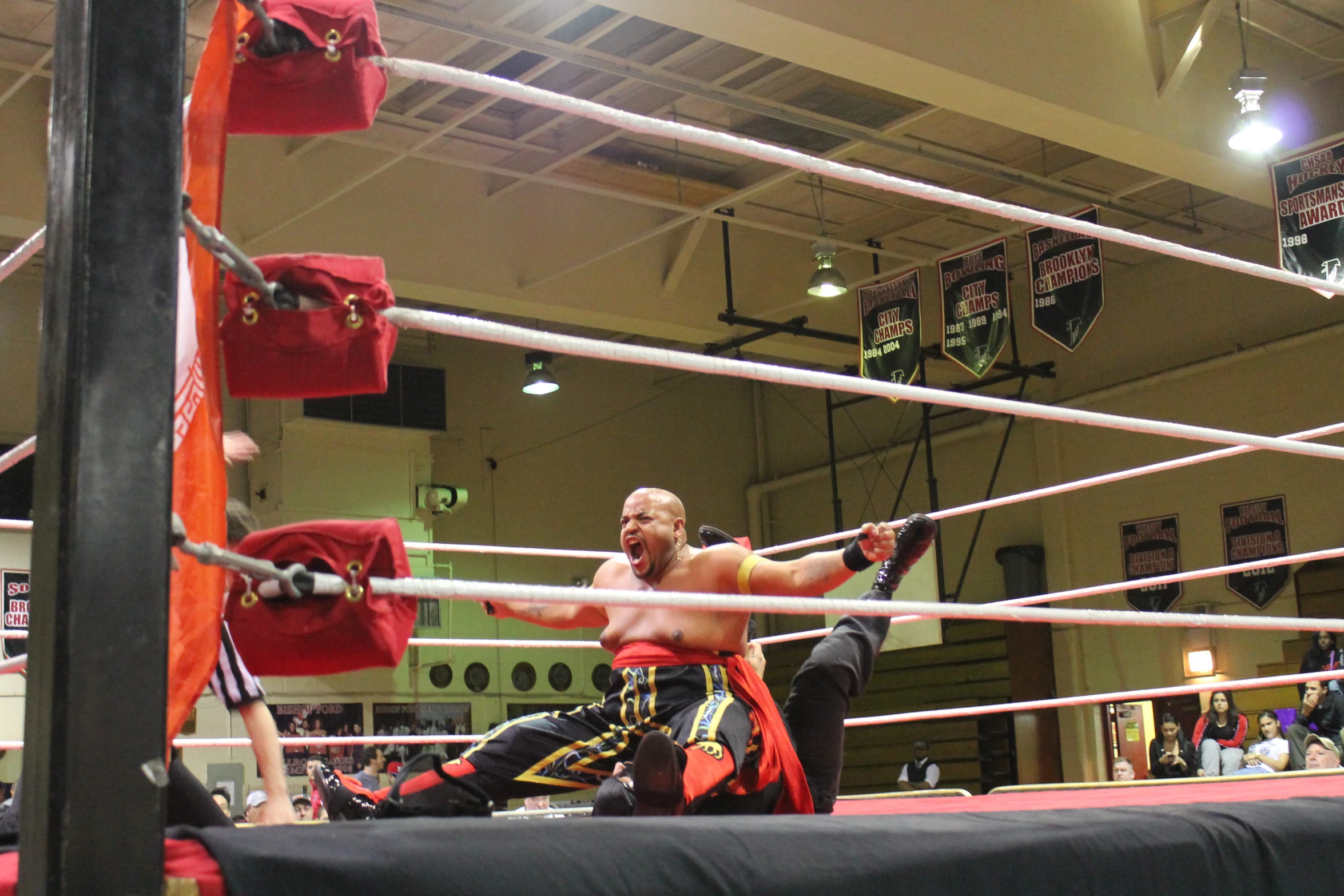 people standing around in an indoor boxing ring