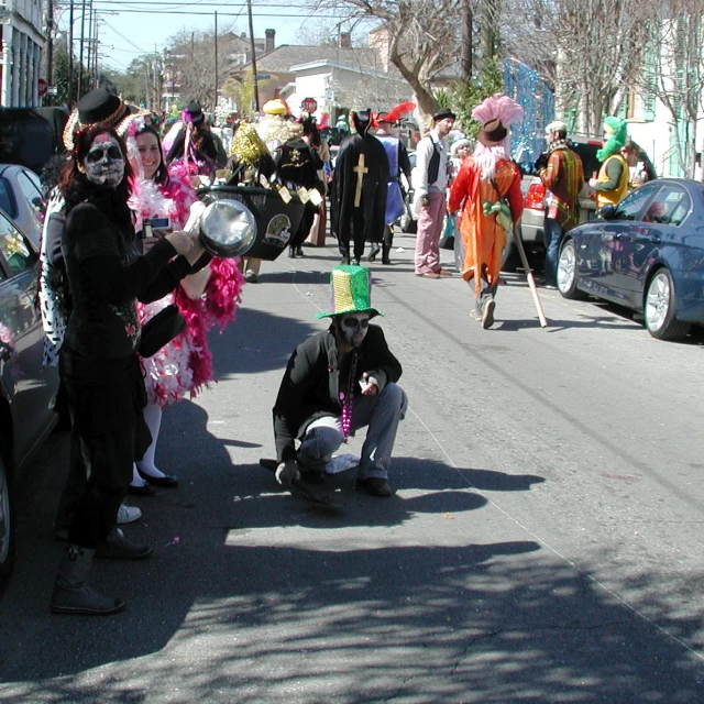 two people wearing costumes stand by a street