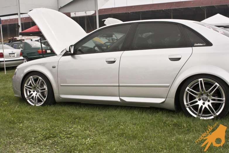 a white car is parked on the grass