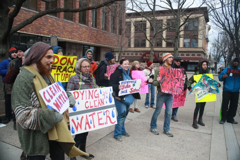 a large group of people standing together with signs