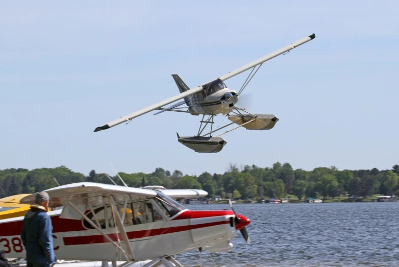 two sea planes sit parked next to each other