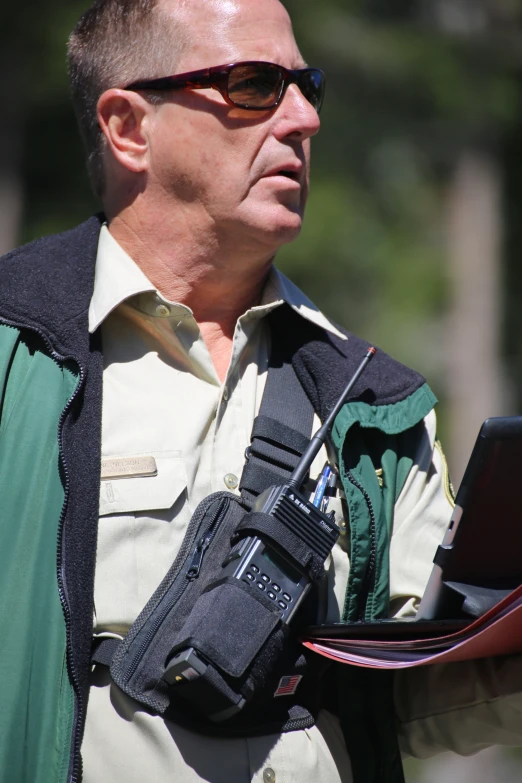 a man with sunglasses wearing a camera backpack