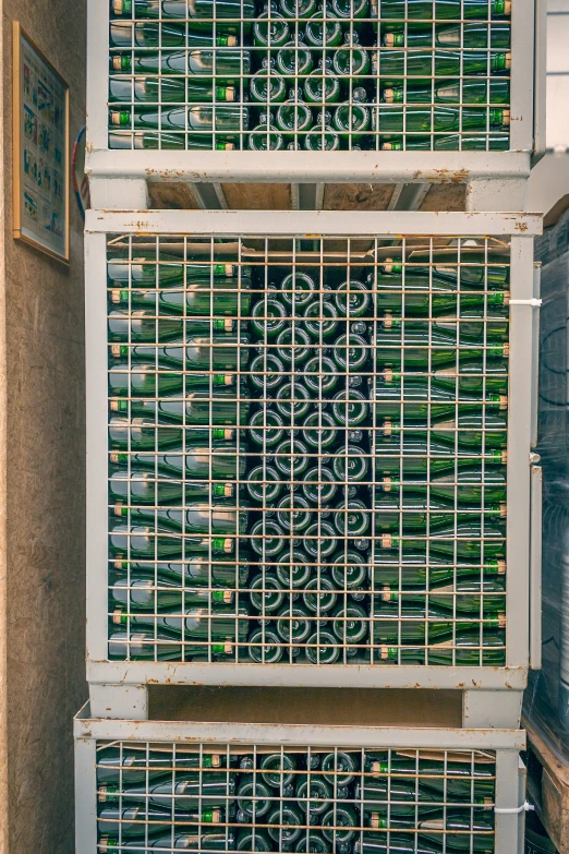 a closeup of two metal baskets full of wine bottles