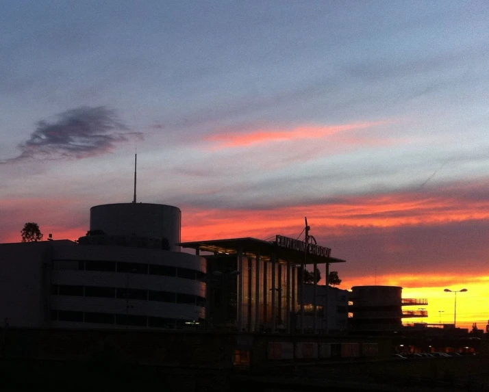 a sunset behind an office building in the background