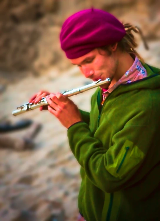 a man in green is playing a flute