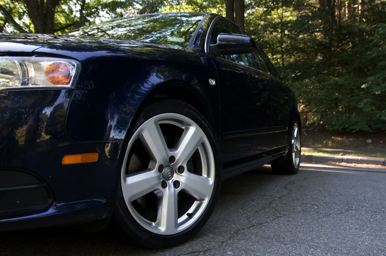 a dark blue car parked on the street