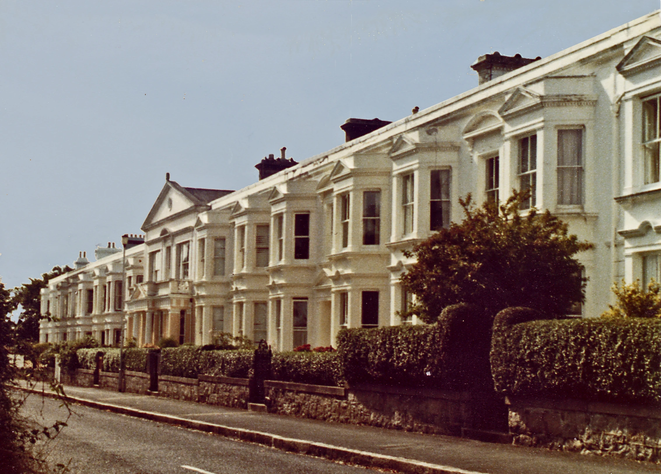 rows of residential houses line an urban street