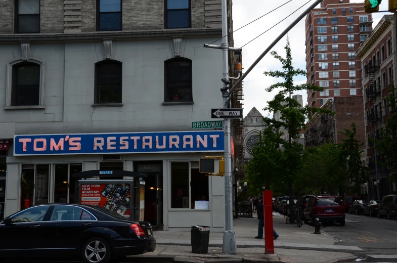 a large building that has a restaurant on the corner