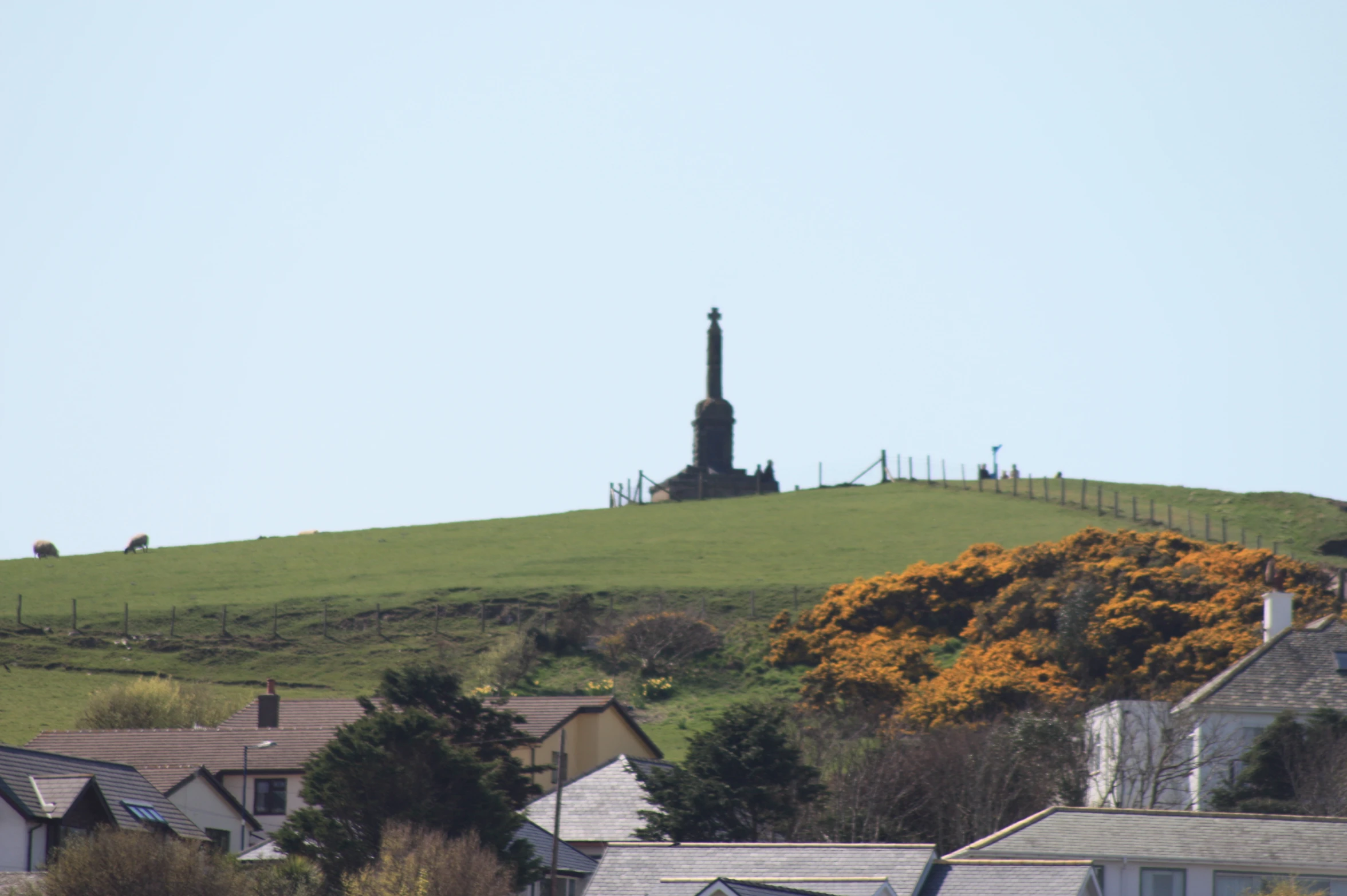 the view of a hill, including the church spire