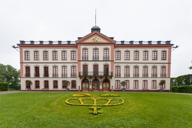 an outside view of a large building with a green lawn