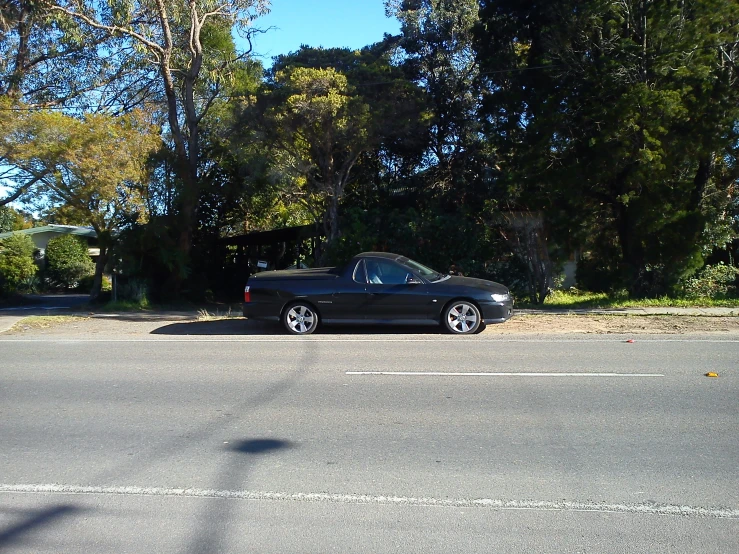 a black car parked on the side of a street