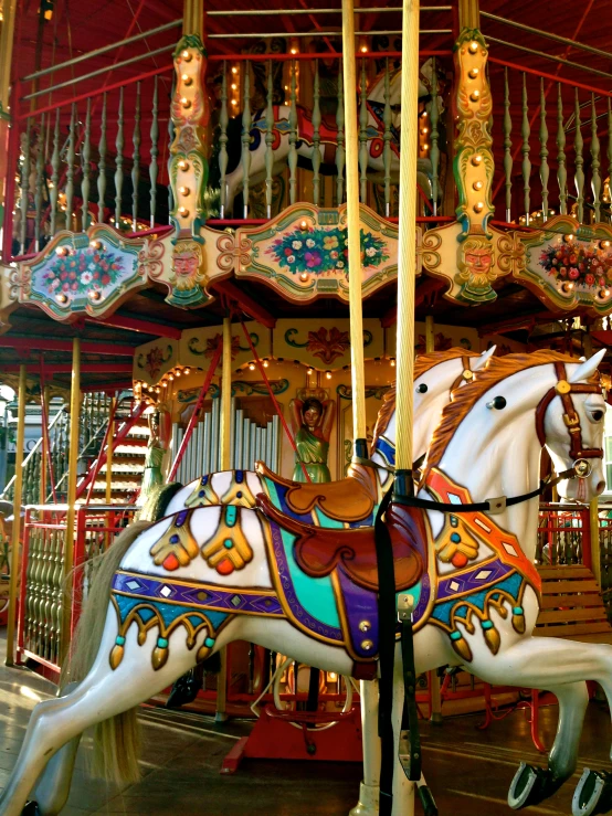 two white horses on a carnival ride
