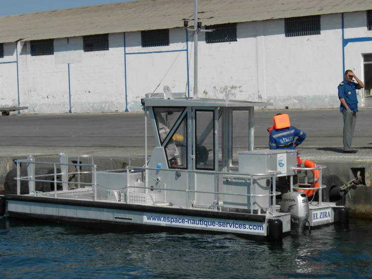 a man on a phone near a boat