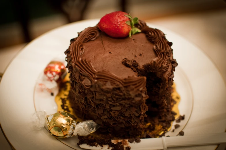 a chocolate cake is decorated with candies on a plate