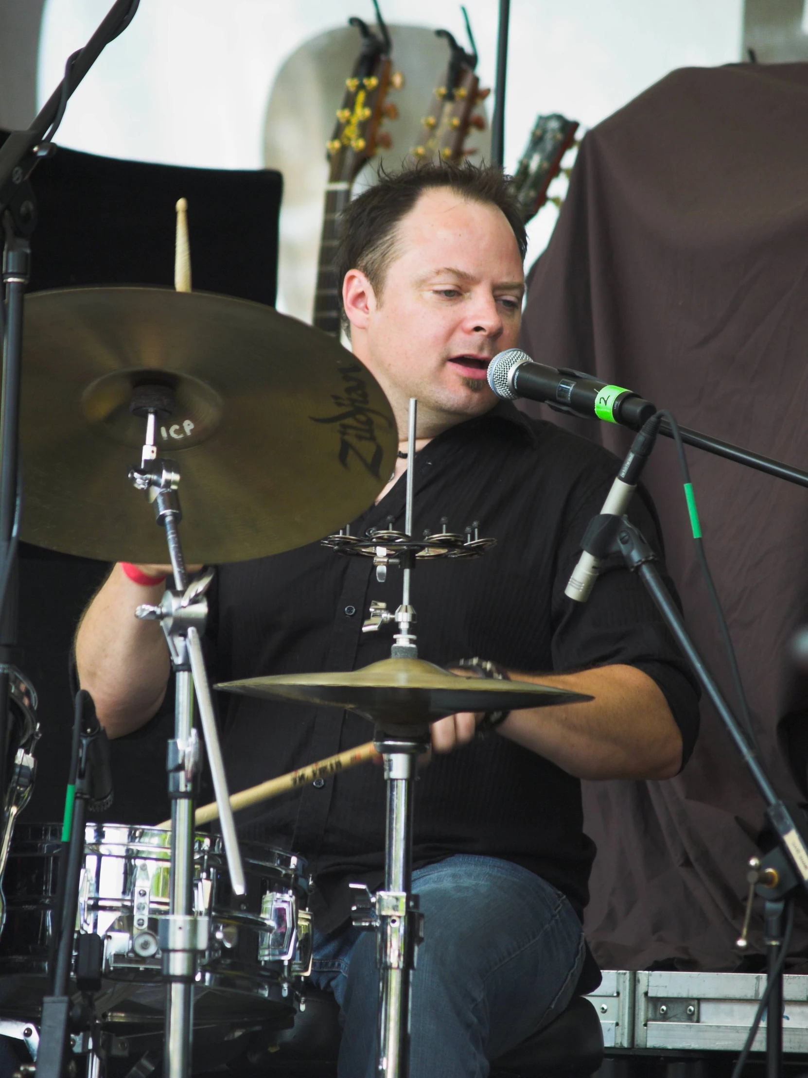 a drummer is holding his drums and playing a musical instrument