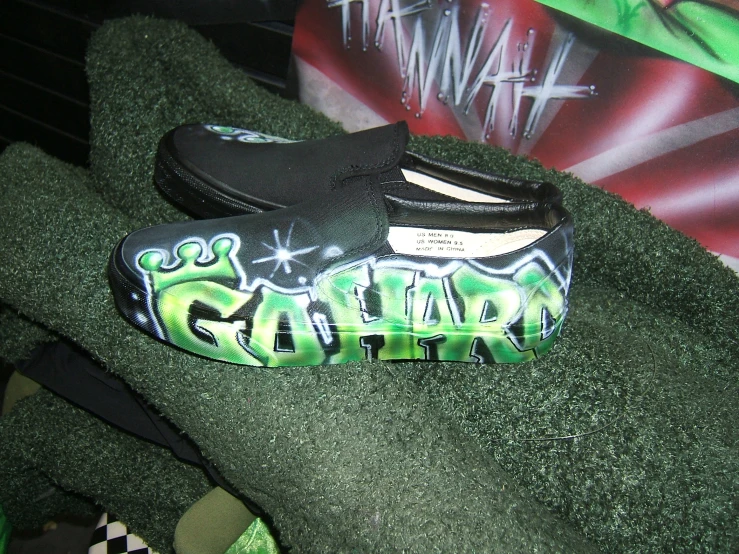 a pair of black slippers covered in graffiti