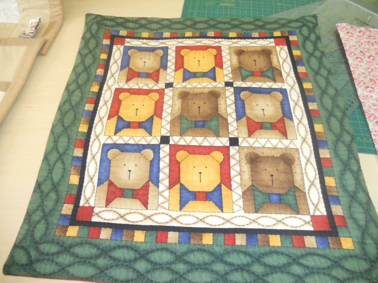 the teddy bear block has been quilted onto the cloth