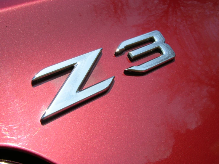 the hood emblem on the red sports car