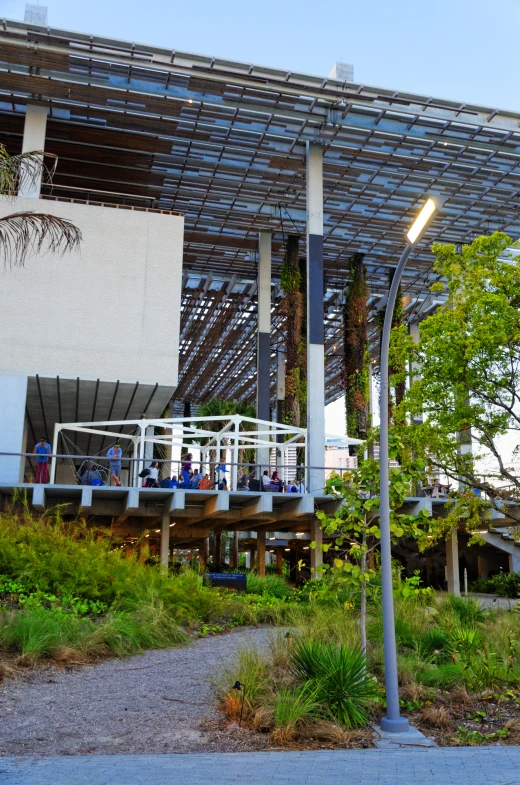 an open building with many people sitting on a balcony