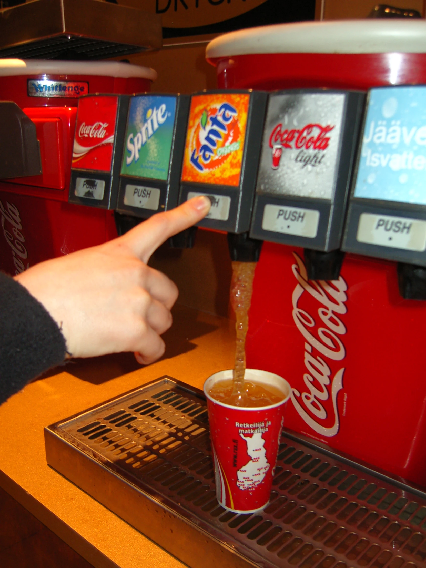 a person presses an order of some soft drink