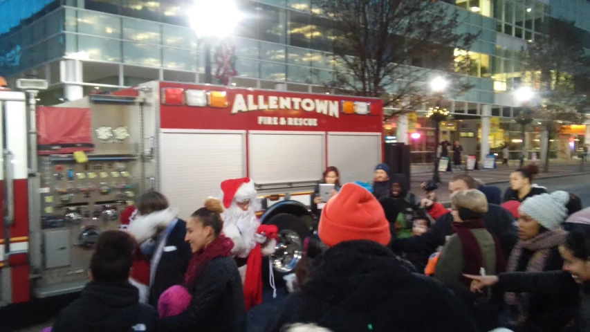 a large crowd of people around a firetruck