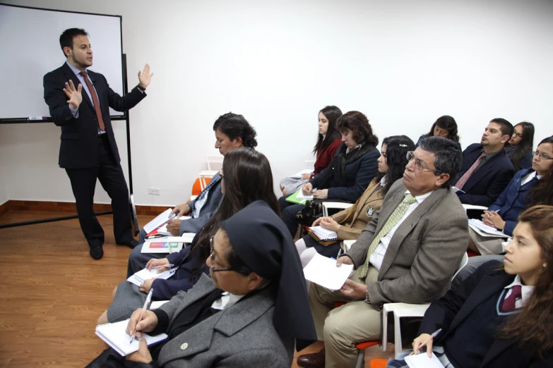 a man is giving a lecture to a group