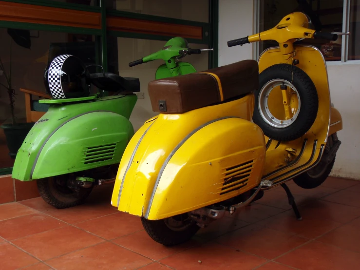 two bright green motorcycles parked on brick sidewalks
