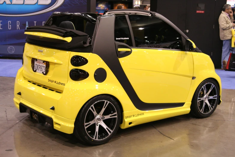 a smart car on display at an auto show